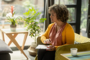 Woman in yellow discusses the intersection of mental health and diversity, equity, and inclusion (DEI)